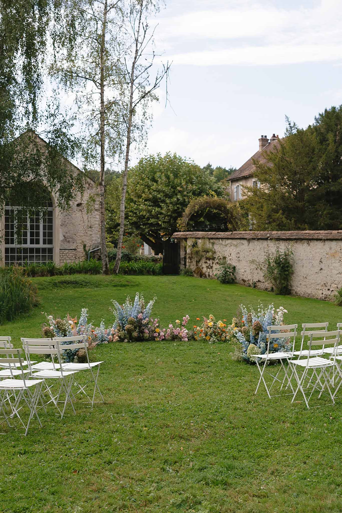 Wedding ceremony setup in a garden with white roses