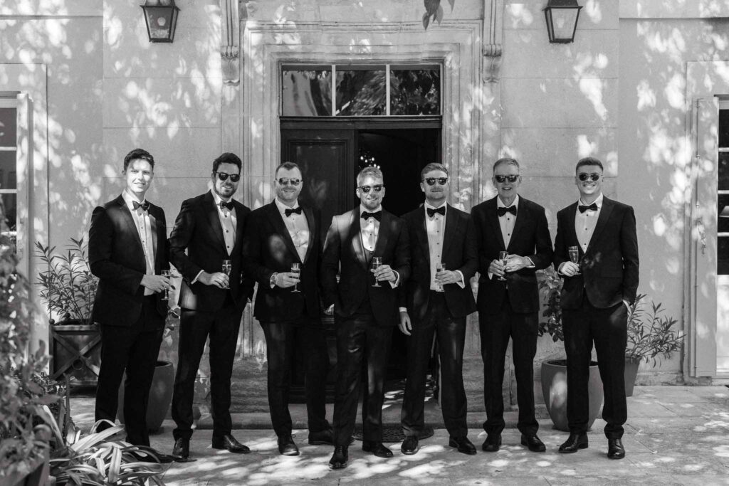 Tour Vaucros S.Rached groomsmen groom tuxedo holding champagne glass