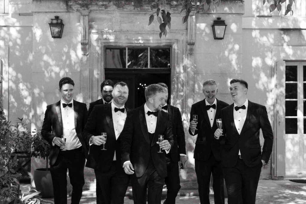 Tour Vaucros S.Rached groomsmen tuxedo walking holding glasses