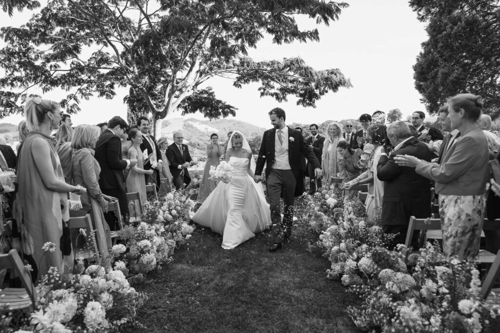 Maison Belzunce S.Castillo couple walking down aisle petal toss