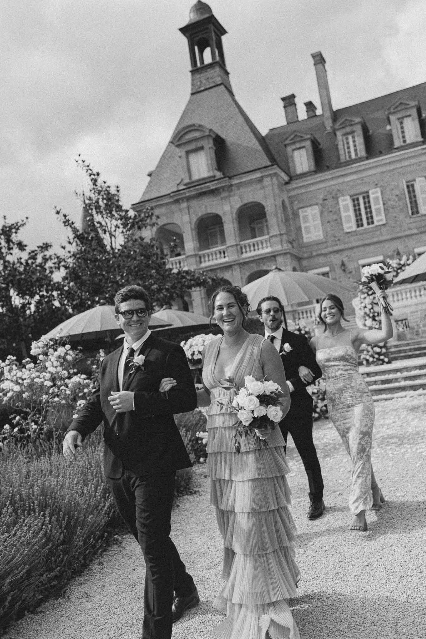 Black and white photo of wedding reception room with white roses