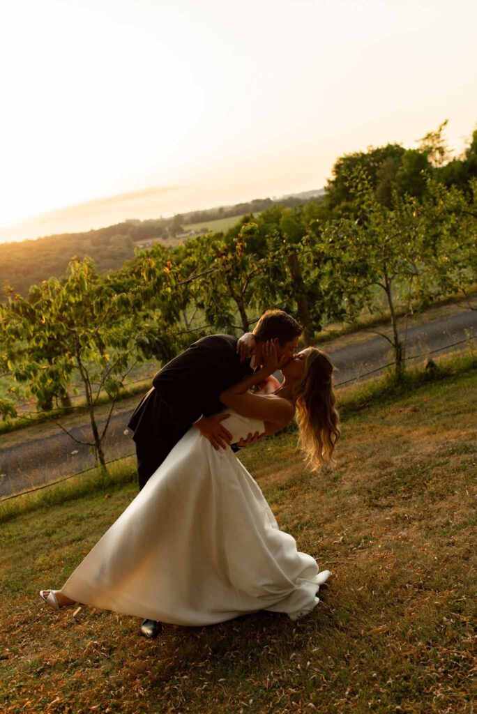 d Essendiéras K.Hiscox golden hour couple dip kiss vineyard
