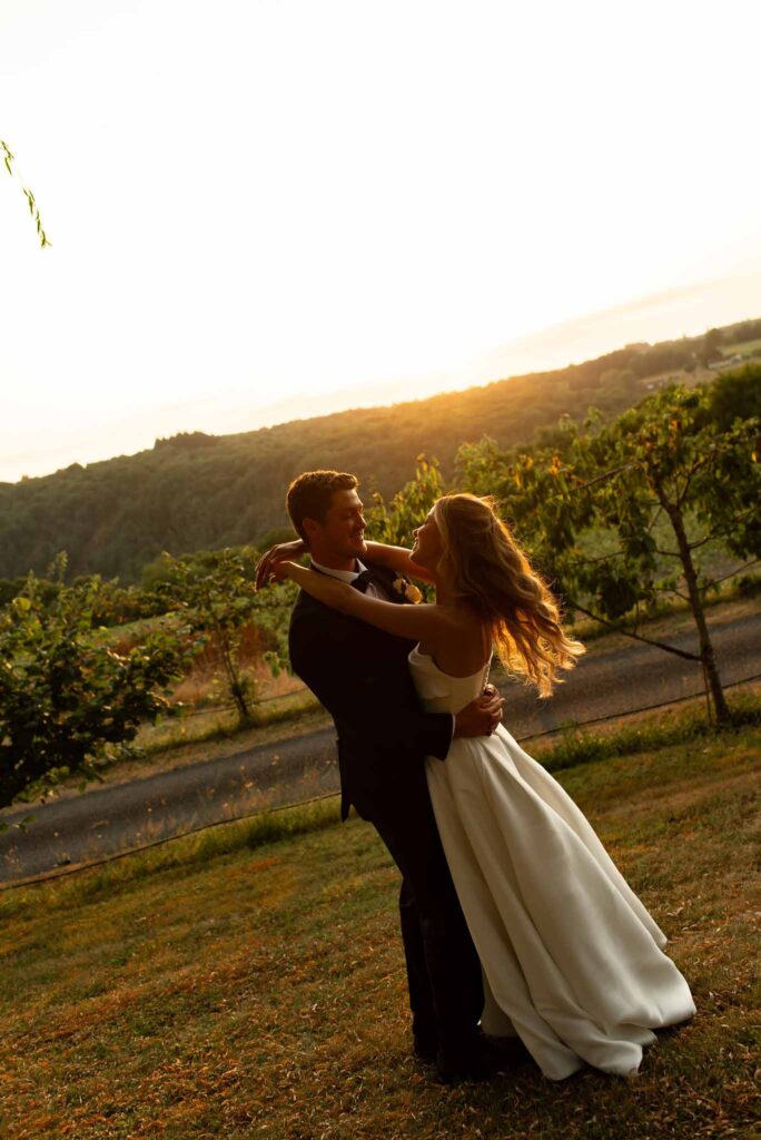 d Essendiéras K.Hiscox golden hour couple hug vineyard